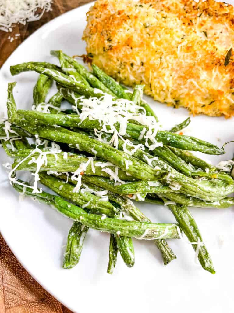 Parmesan Air Fried Green Beans on a plate with chicken