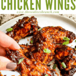 Pin image of a hand grabbing a Barbeque Chicken Wing with title at top