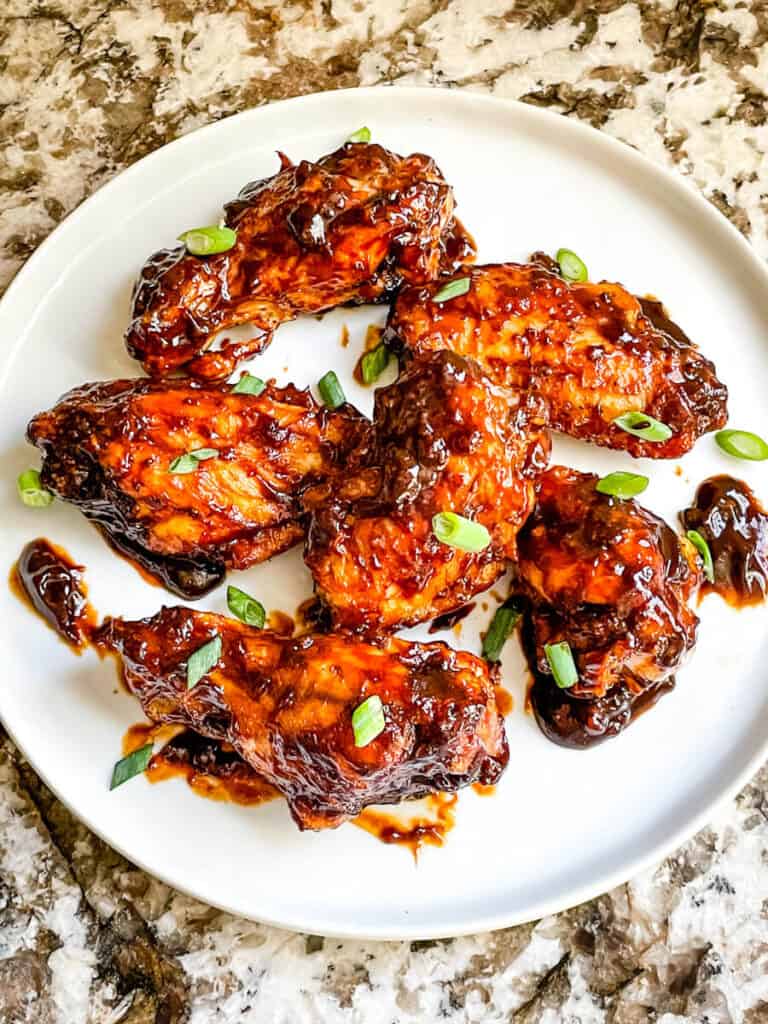 Top view of Barbeque Chicken Wings on a white round plate