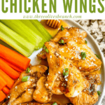 Pin image of Honey Garlic Chicken Wings on a plate with carrots and celery with title at top