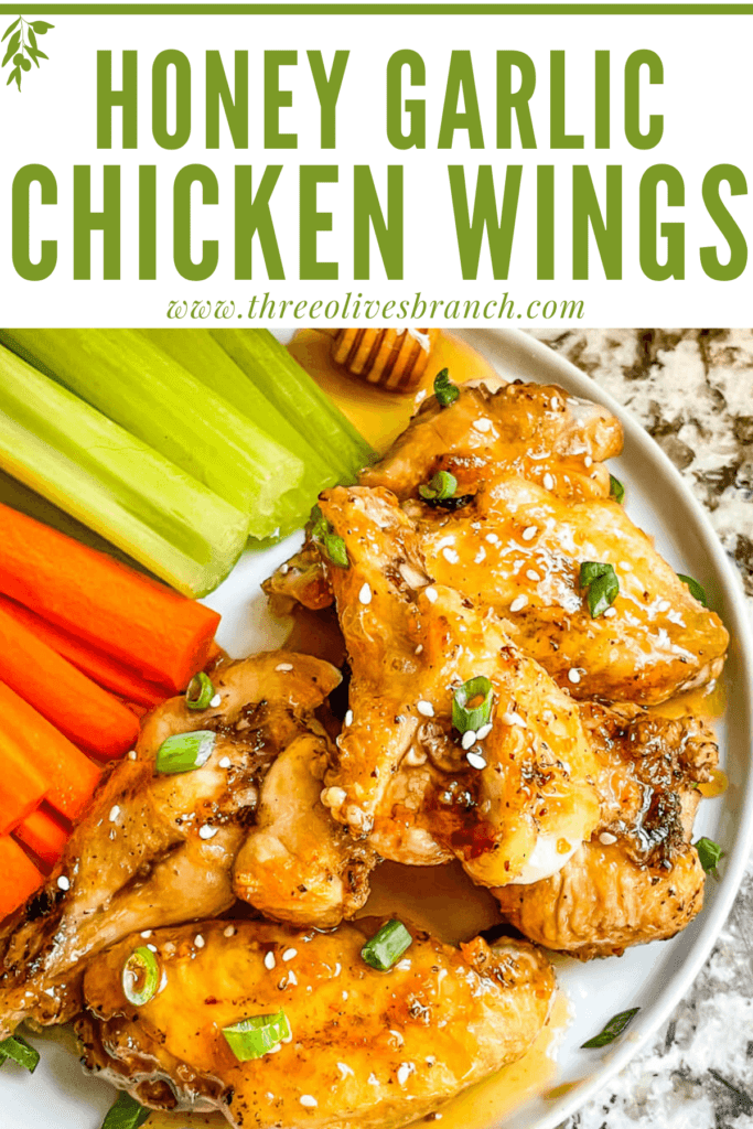 Pin image of Honey Garlic Chicken Wings on a plate with carrots and celery with title at top