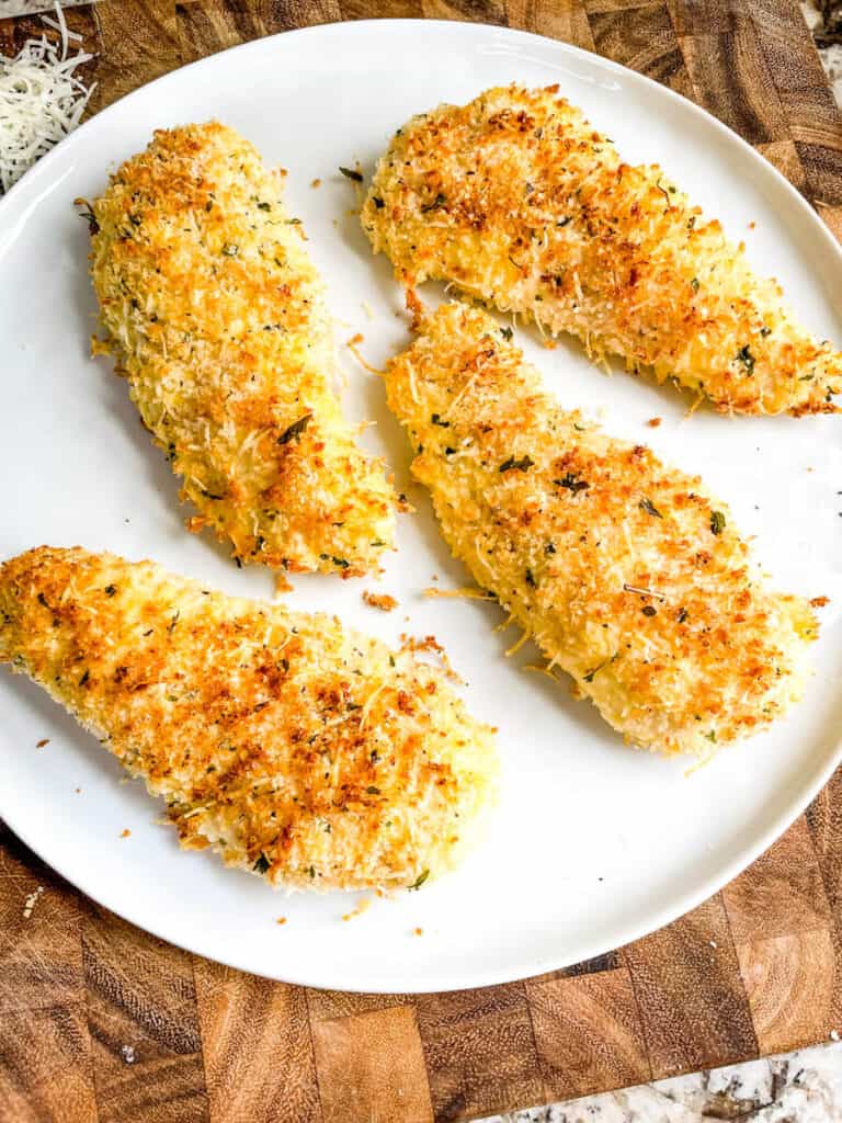 Four Parmesan Air Fried Chicken Tenders on a white plate