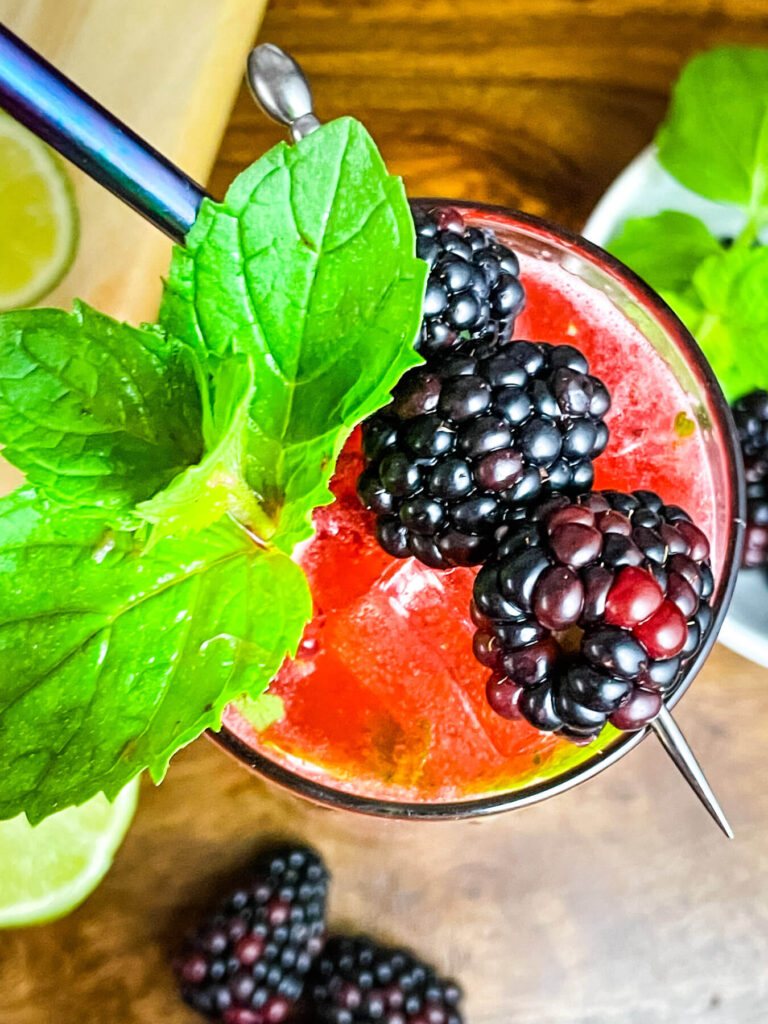Top view of the drink in a glass with mint and berries