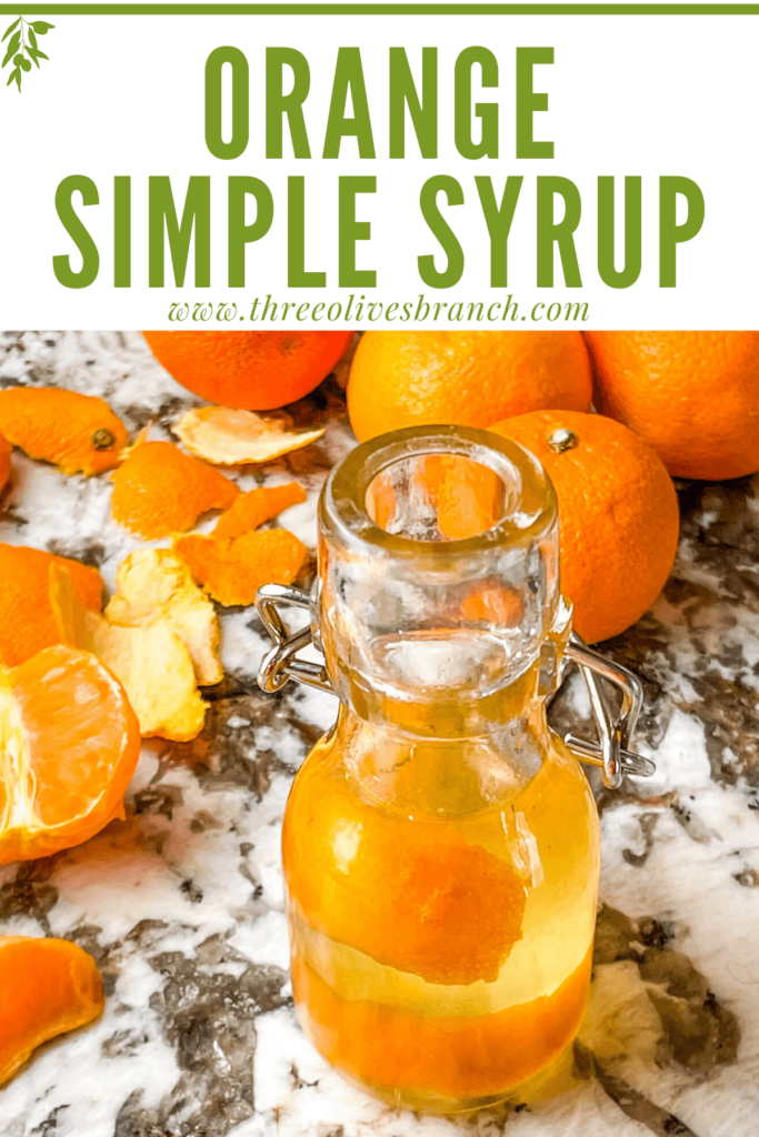 Pin of Orange Simple Syrup in a small bottle with oranges around it and title at top