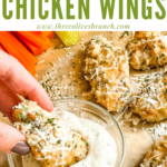 Pin of a hand dunking a Parmesan Garlic Chicken Wing in sauce with title at top