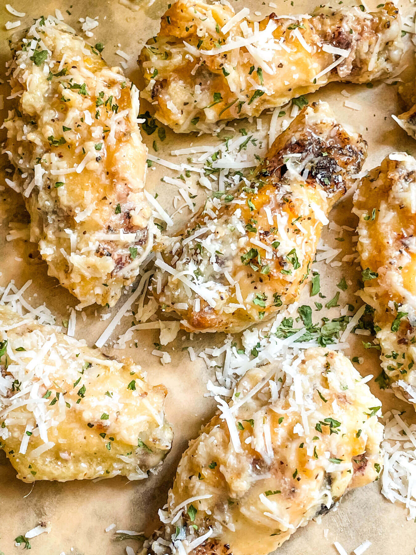 Parmesan Garlic Chicken Wings spread out on butcher paper