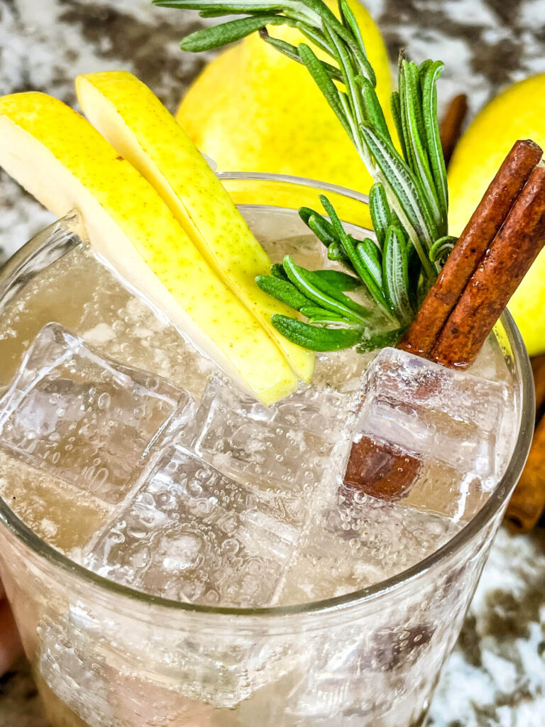 Close up of the top of a Pear Tree Vodka Cocktail with garnishes