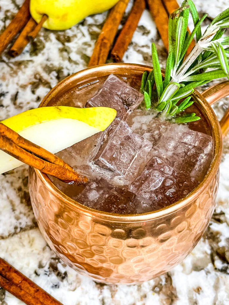 Top view of Pear Tree Vodka Cocktail in a copper mug with garnishes