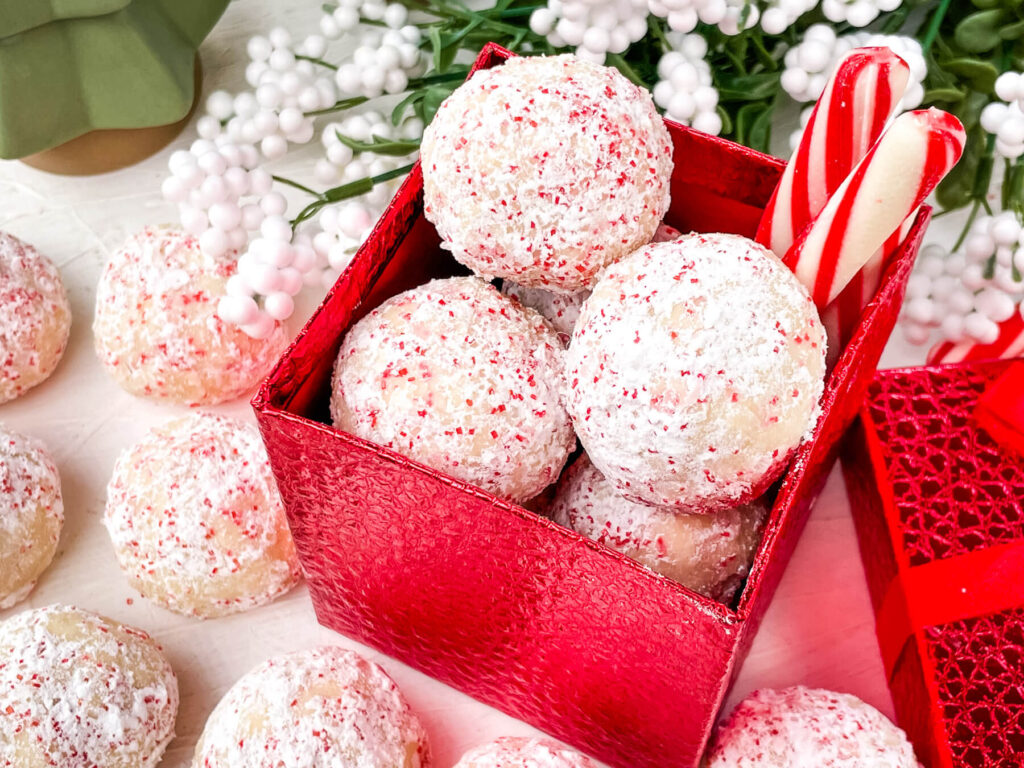 Peppermint Snowball Cookies in and around a red box