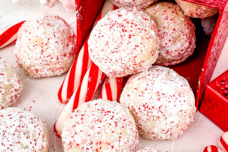 Peppermint Snowball Cookies pouring out of a little red box
