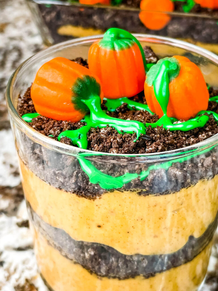 Close up of a small Pumpkin Patch Dirt Pudding Dessert in a clear cup