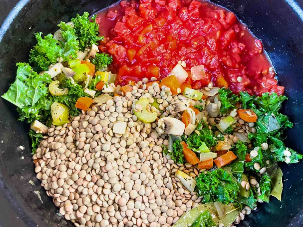 The pot with lentils, tomatoes, and kale added