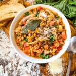 Top view of Turkey Lentil Soup in a white bowl on a wood board