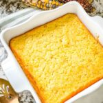 A finished Corn Casserole in a white square dish