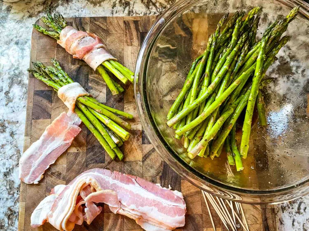 Asparagus being bundled and wrapped in bacon slices