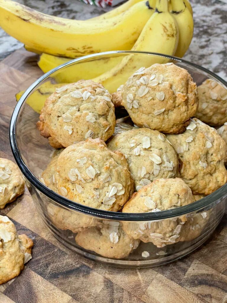 Banana Oatmeal Cookies in a glass bowl on a cutting board