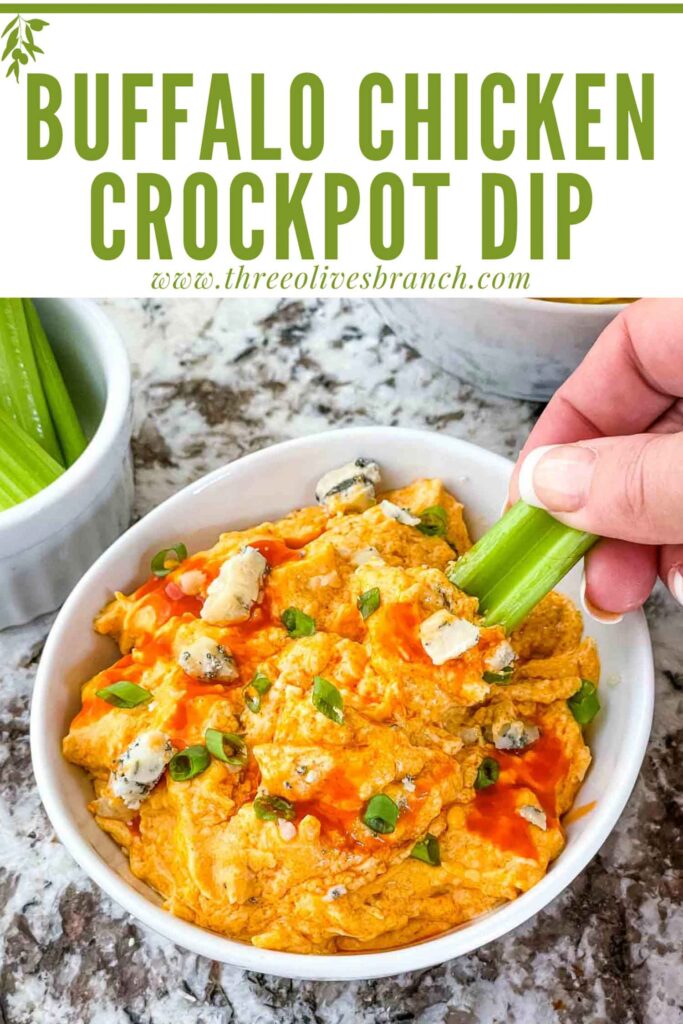 Pin of Buffalo Chicken Crockpot Dip in a bowl with a hand dipping celery into it and title at top