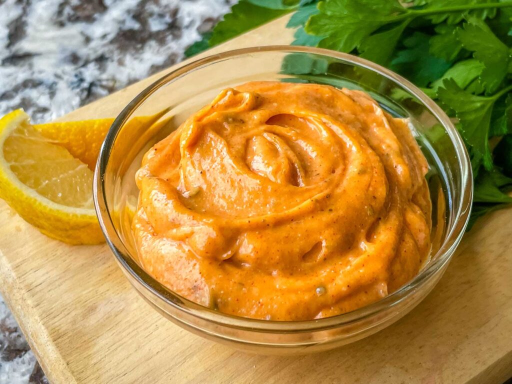 Cajun Sauce in a clear bowl on a cutting board