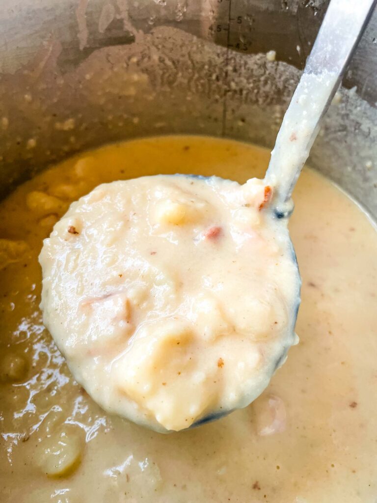 A ladle scooping the soup out of the pot