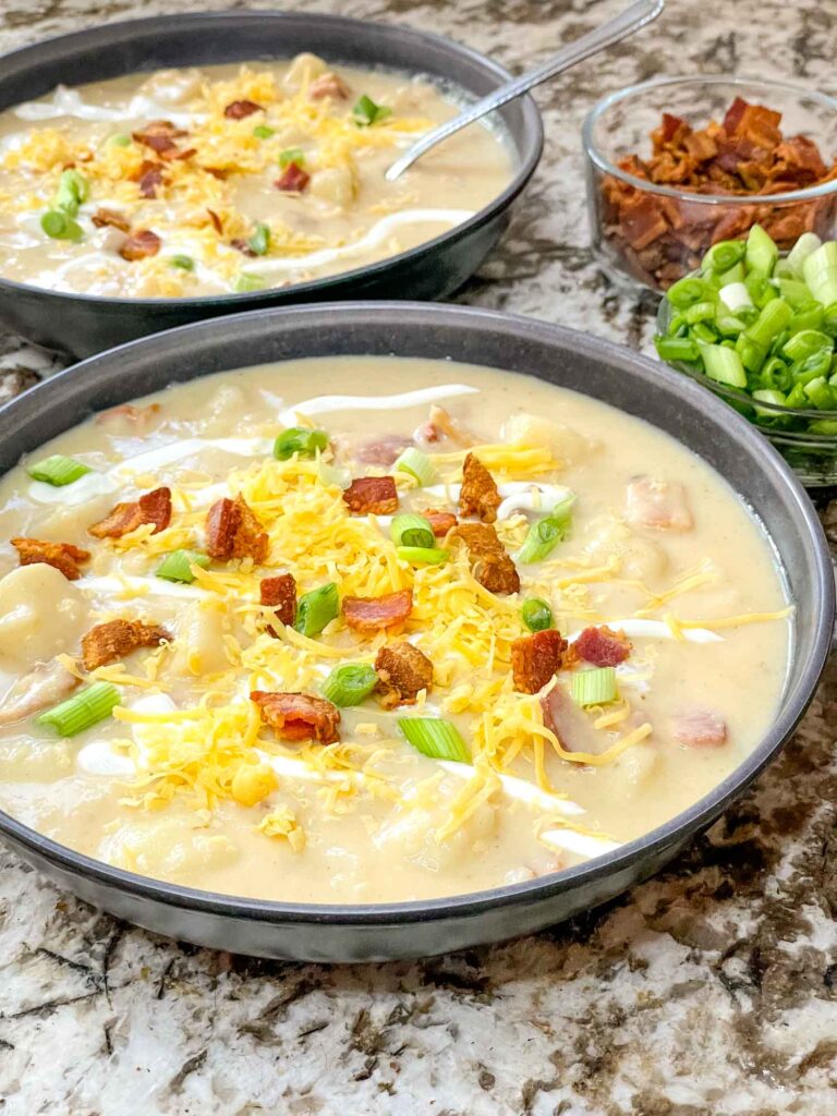 Two bowls of Instant Pot Potato Soup with toppings