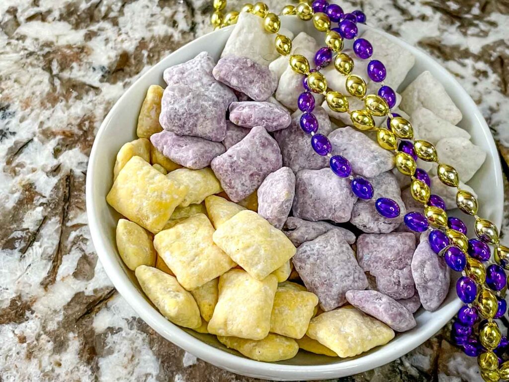 The yellow, purple, and white muddy buddies in a bowl with bead necklaces