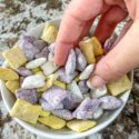 A hand grabbing Minnesota Vikings Puppy Chow out of a bowl