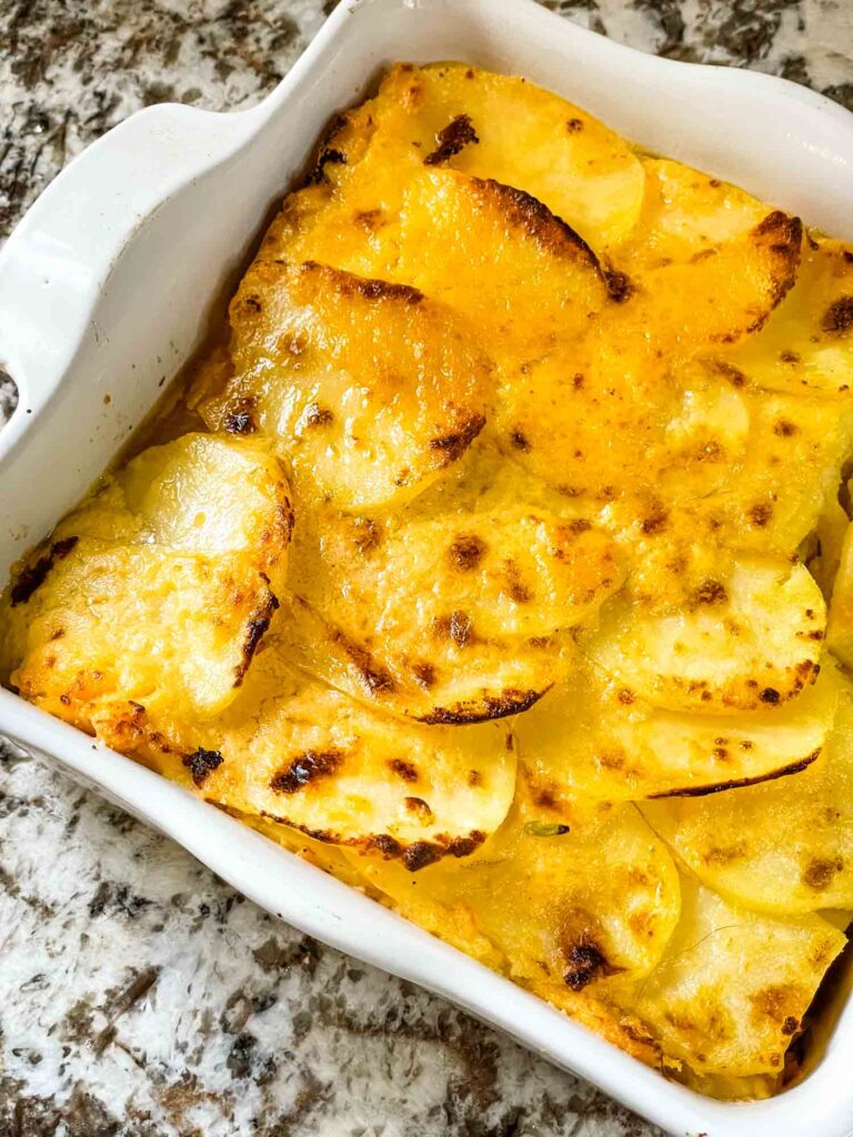 Dish full of Scalloped Cheesy Potatoes from the top