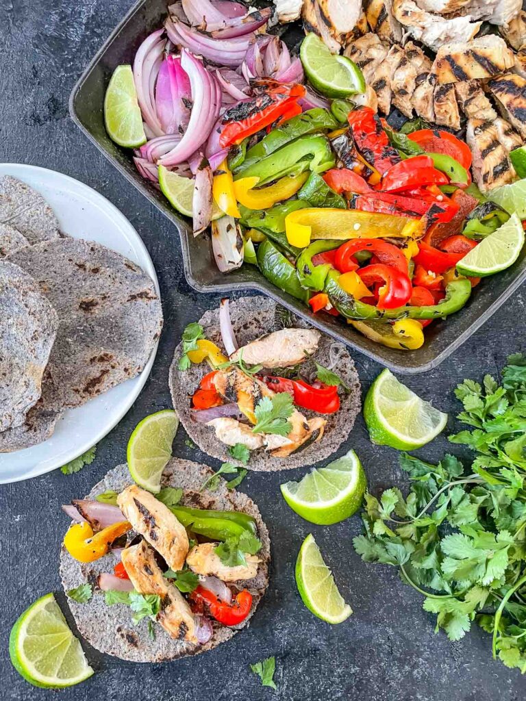 Top view of Chicken Fajita Tacos being served and two assembled tacos