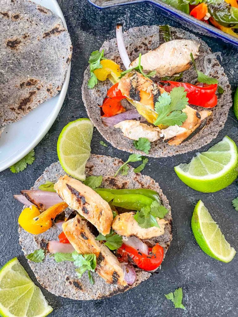 Two Chicken Fajita Tacos on blue corn tortillas