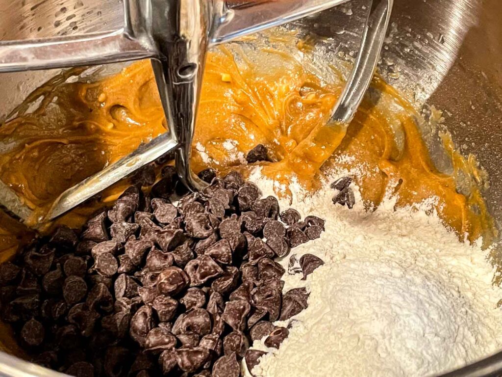 The batter being mixed with flour and chocolate in a mixer