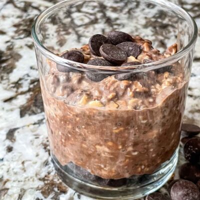 Chocolate Overnight Oats in a glass jar with some chocolate chips on top