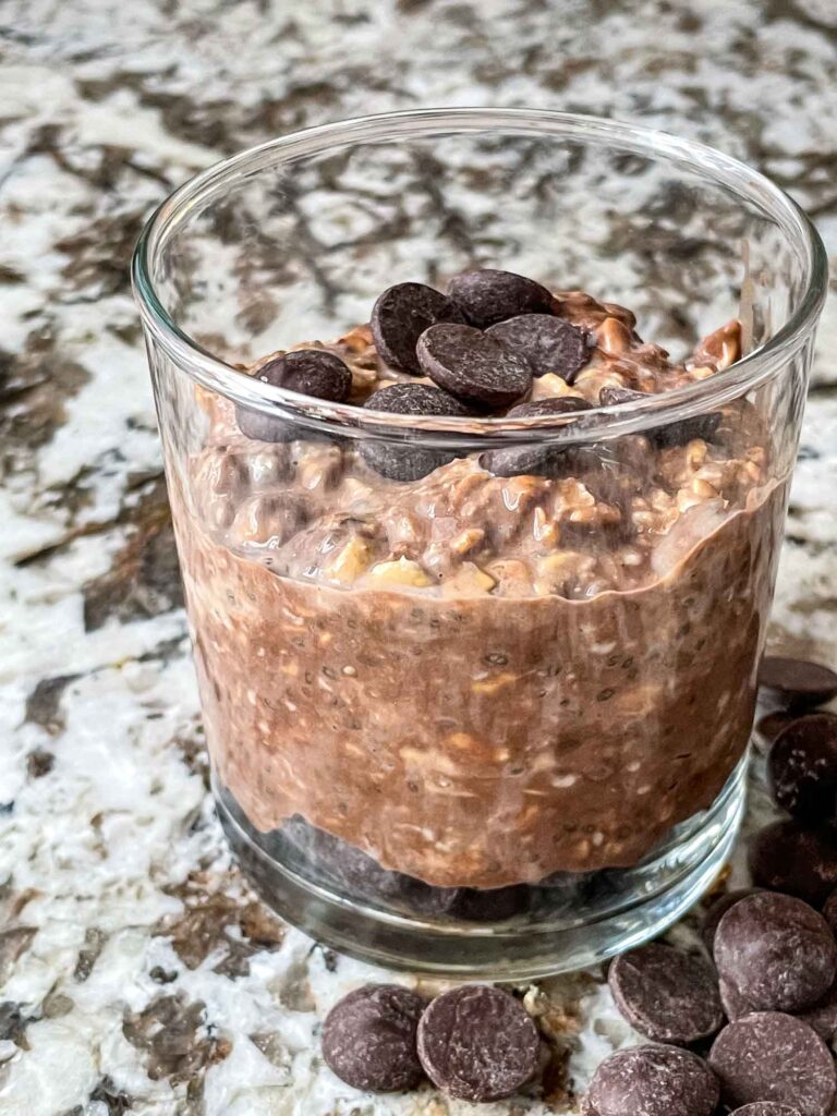 Chocolate Overnight Oats in a glass jar with some chocolate chips on top