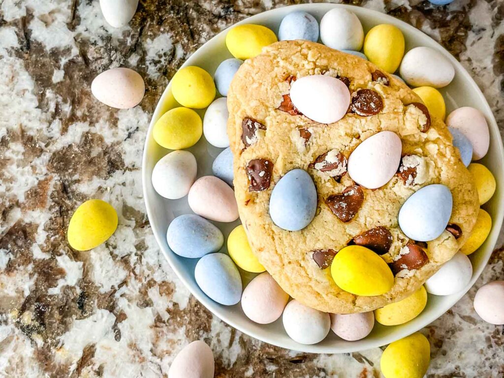 A large cookie on a bed of mini eggs