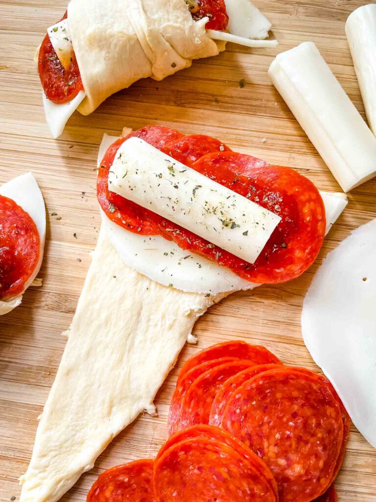 A roll being assembled with all the ingredients stacked