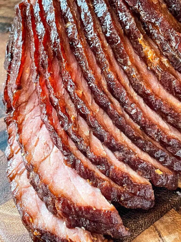 Close up of many Spiral Ham with Brown Sugar Glaze being cut off the bone