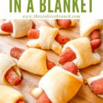 Pin of Vegan Carrot Pigs in a Blanket on a cutting board with title at top