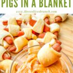 Pin of Vegan Carrot Pigs in a Blanket being dunked into sauce with title at top