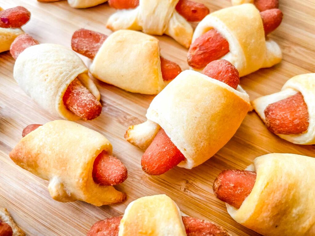 Vegan Carrot Pigs in a Blanket cooked and on a cutting board