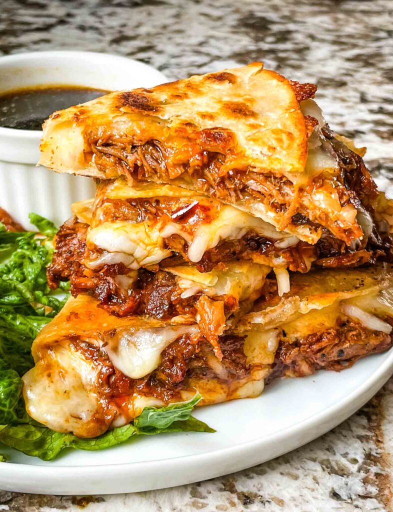 Cut pieces of Birria Quesadilla on a plate