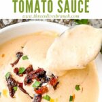 Pin of a spoon scooping into Creamy Sundried Tomato Sauce with title at top