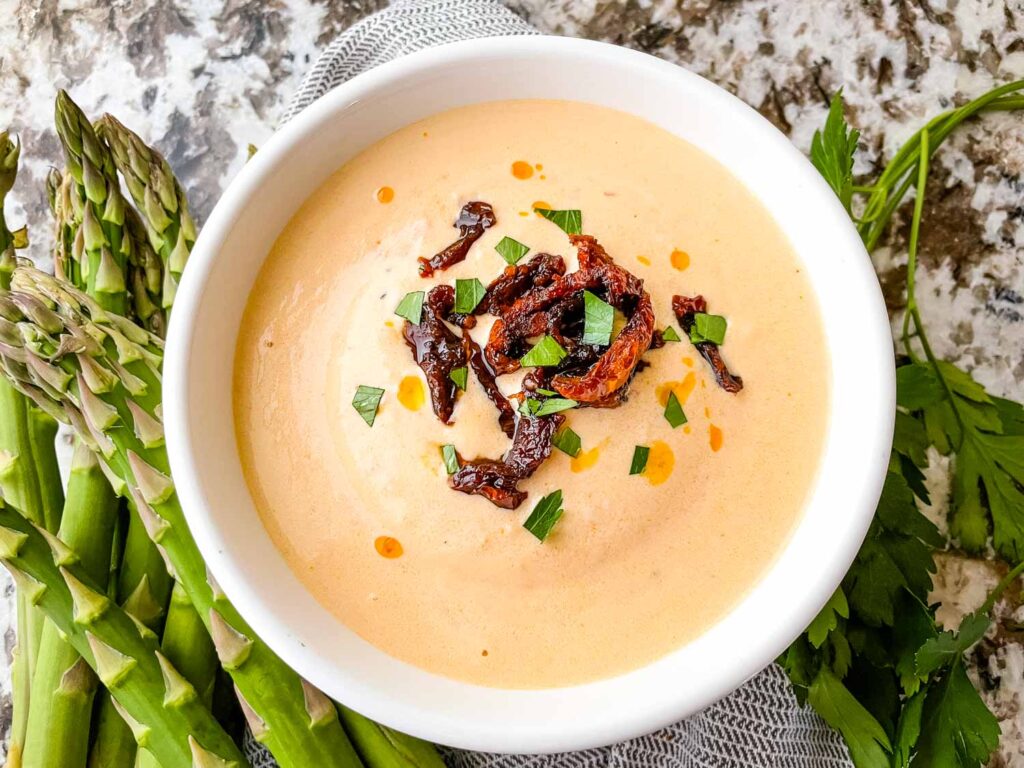 A bowl of Creamy Sundried Tomato Sauce with tomatoes on it