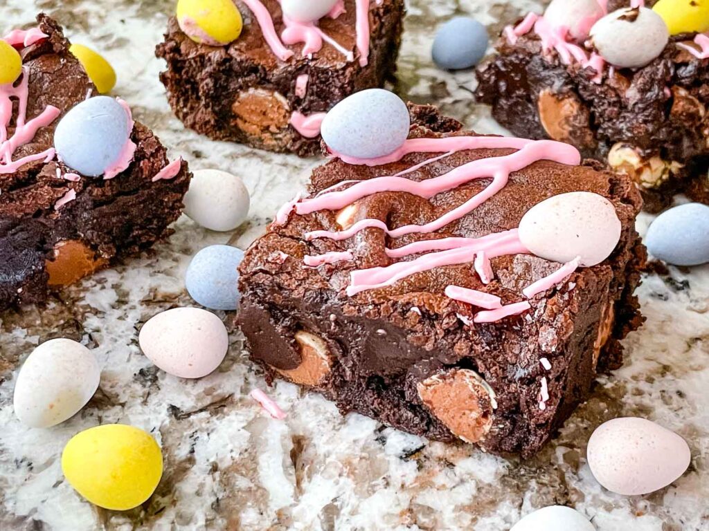 Side view of cut Mini Egg Brownies on a counter