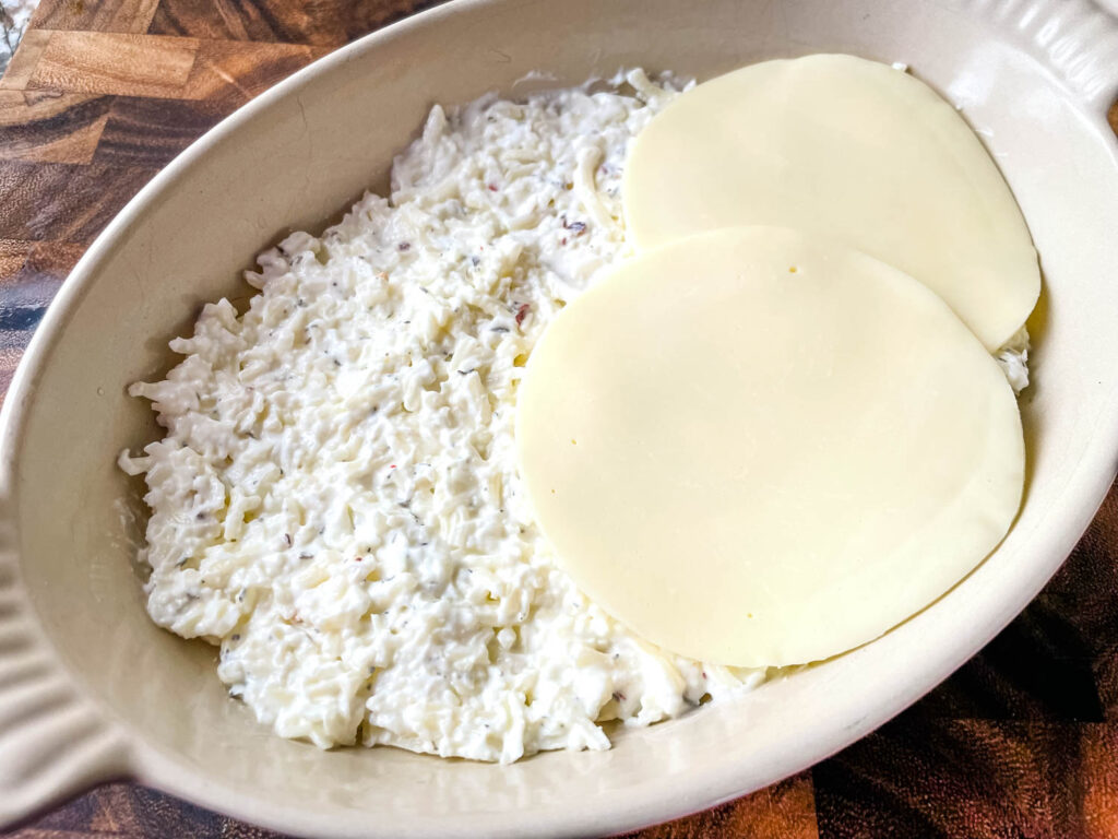 Layering the cheeses in the baking dish