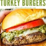 Pin of a hand holding a Pesto Turkey Burger with title at top