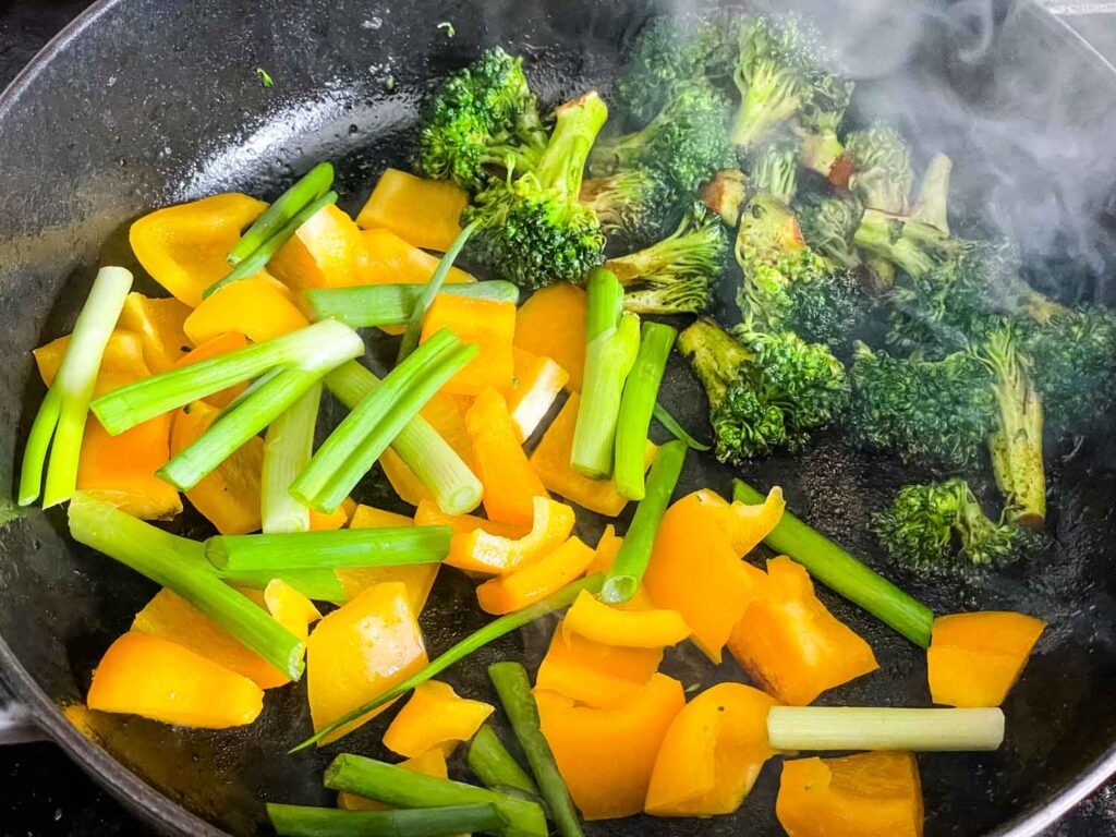 The vegetables cooking in a skillet