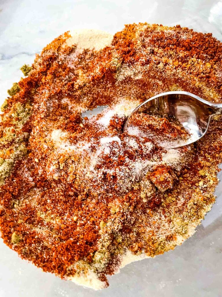 A spoon mixing the BBQ Rub spices together