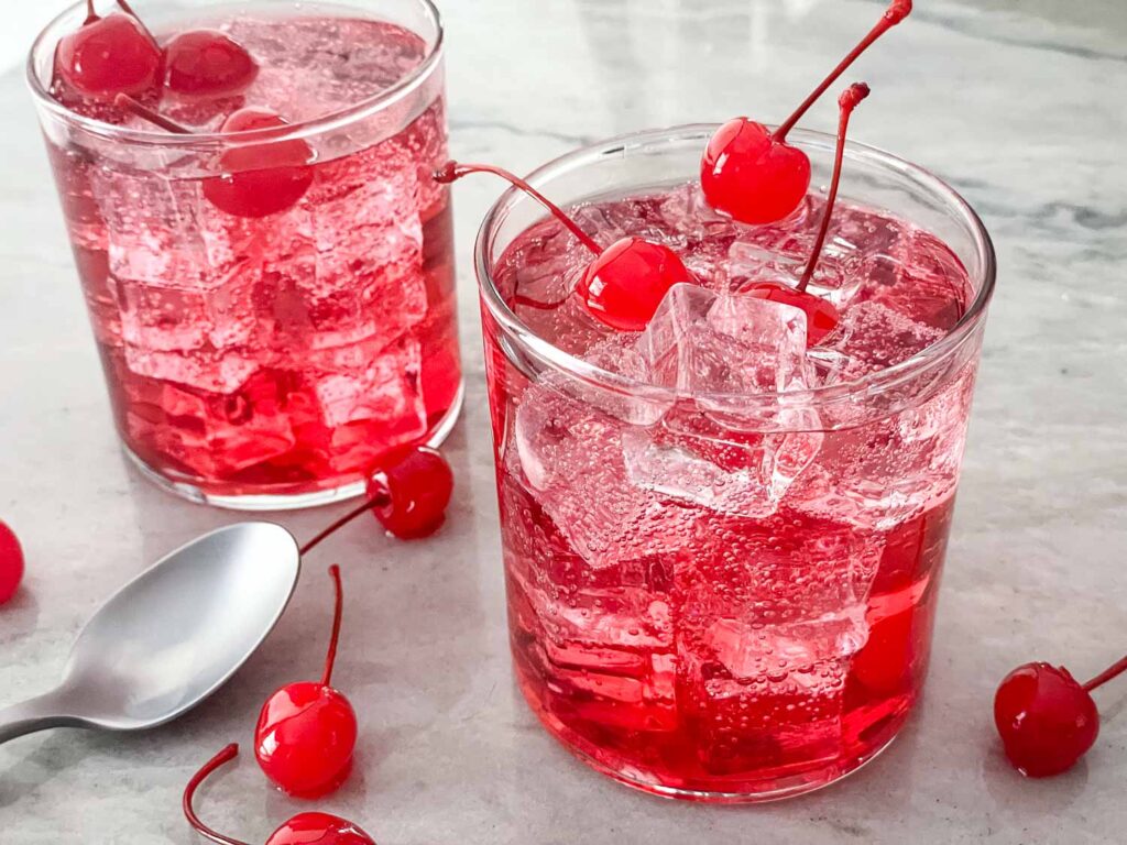 Dirty Shirley cocktails in clear glasses with cherries