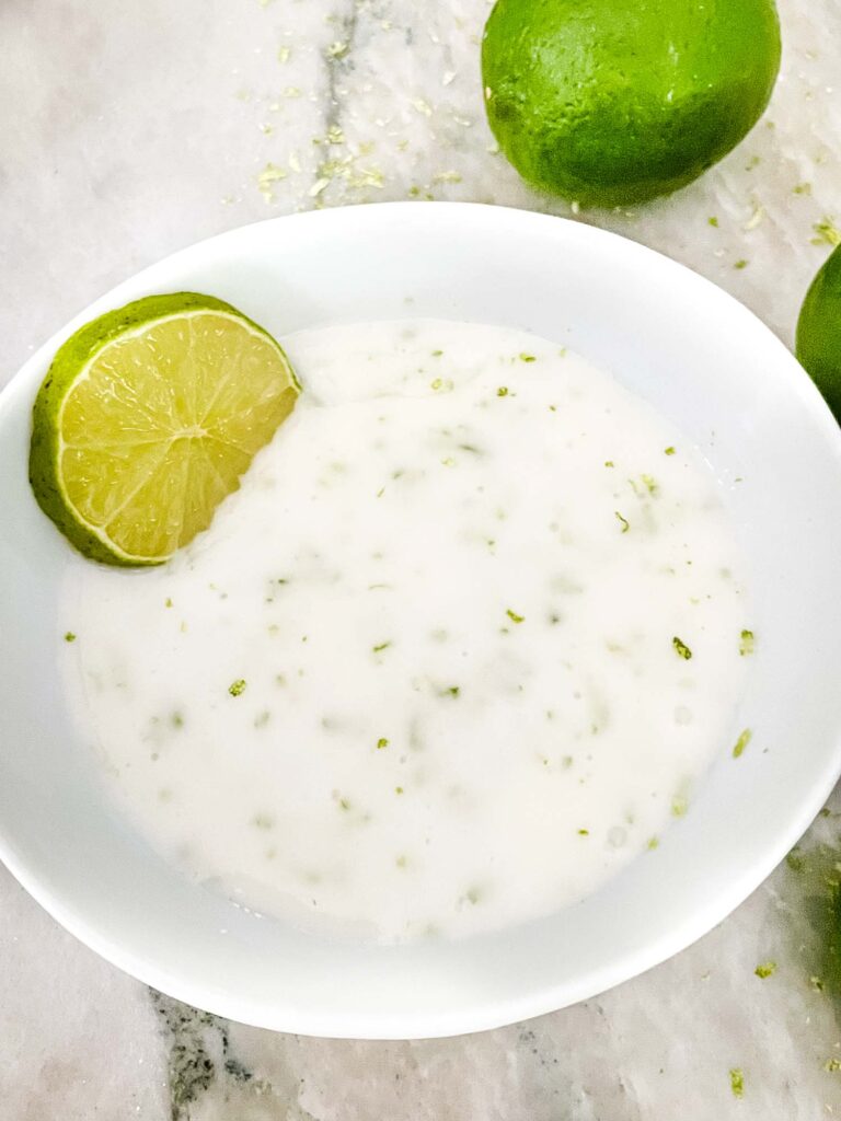 Lime Glaze in a white bowl with limes around it