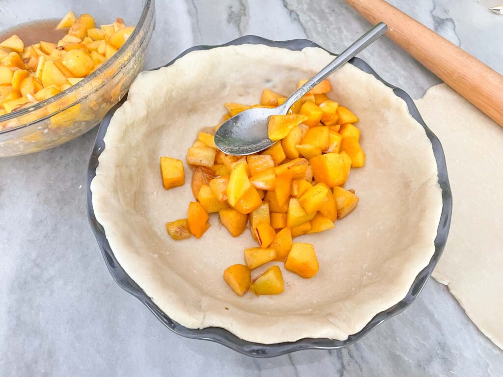 Filling the pie crust with the fruit