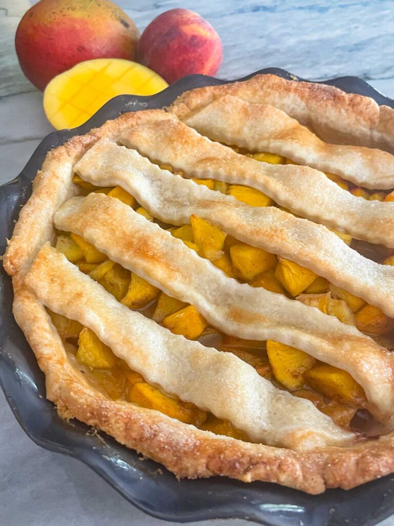 The top of a Peach Mango Pie in a gray dish